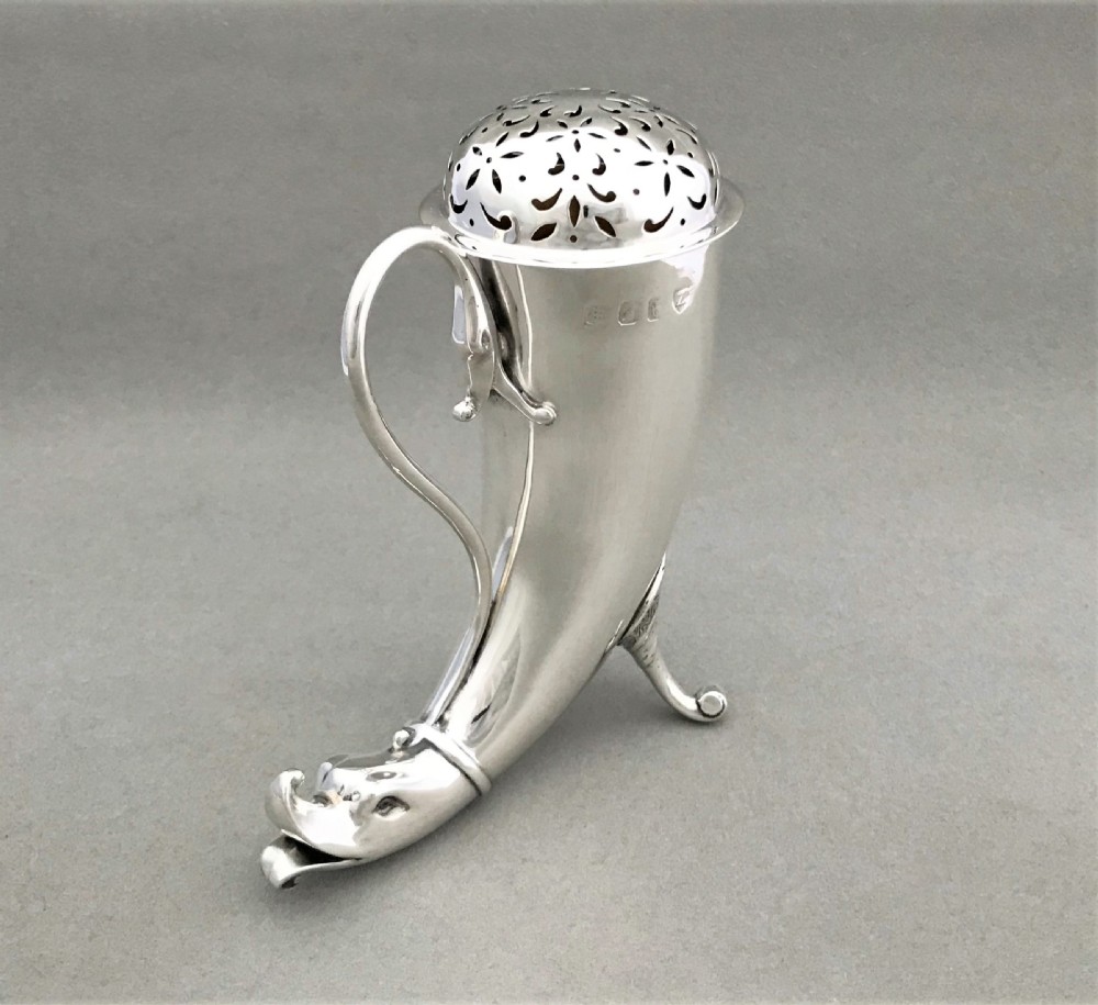 An outstanding Irish silver 'cornucopia' silver sugar caster