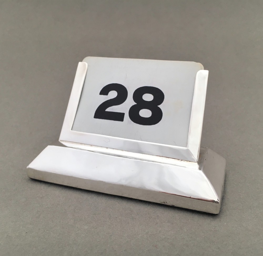 An Edwardian silver perpetual desk calendar
