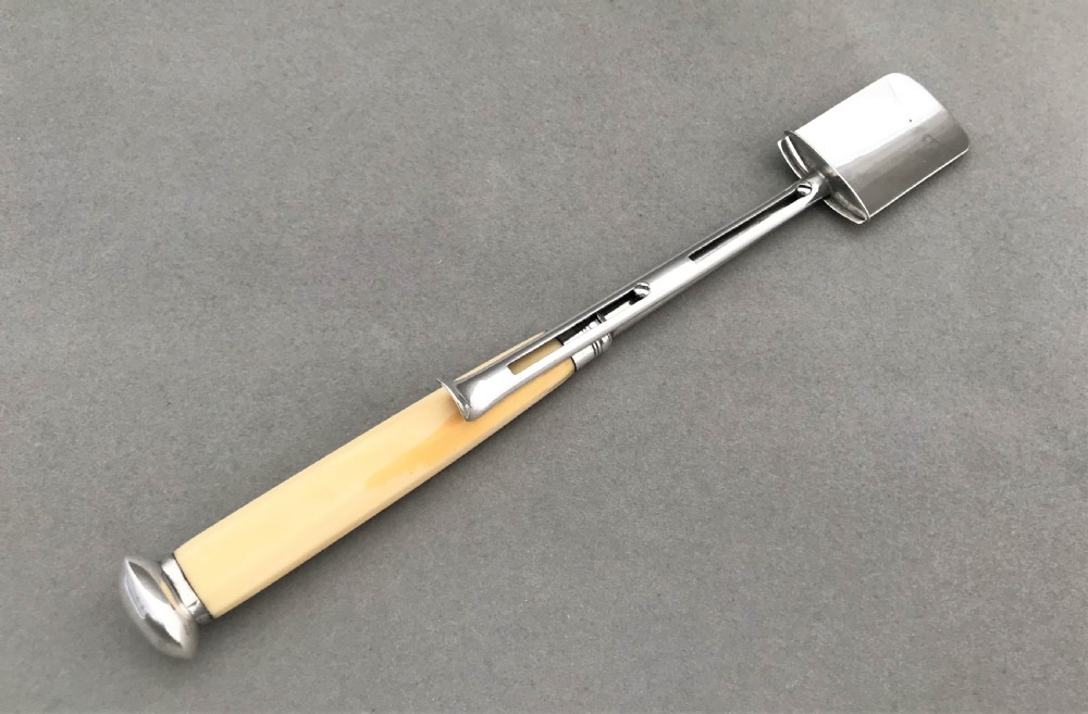 A wonderful Georgian silver stilton scoop with 'push release' mechanism View II