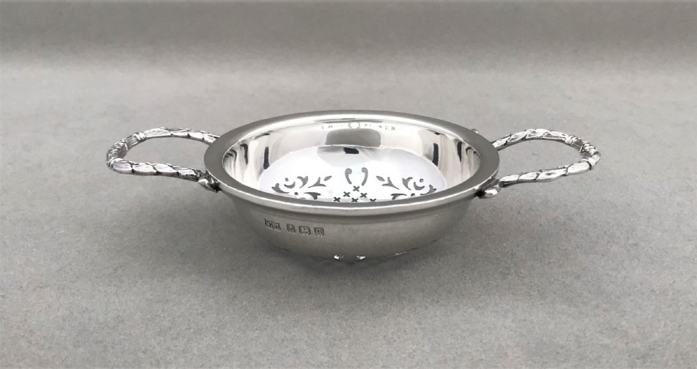 An attractive silver tea strainer View II