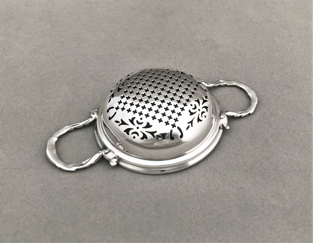 An attractive silver tea strainer View IV