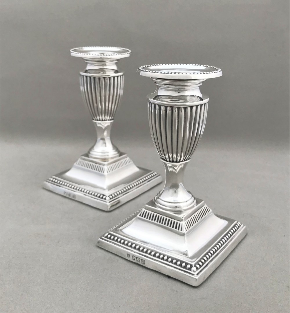 A superb pair of Edwardian half height silver candle sticks