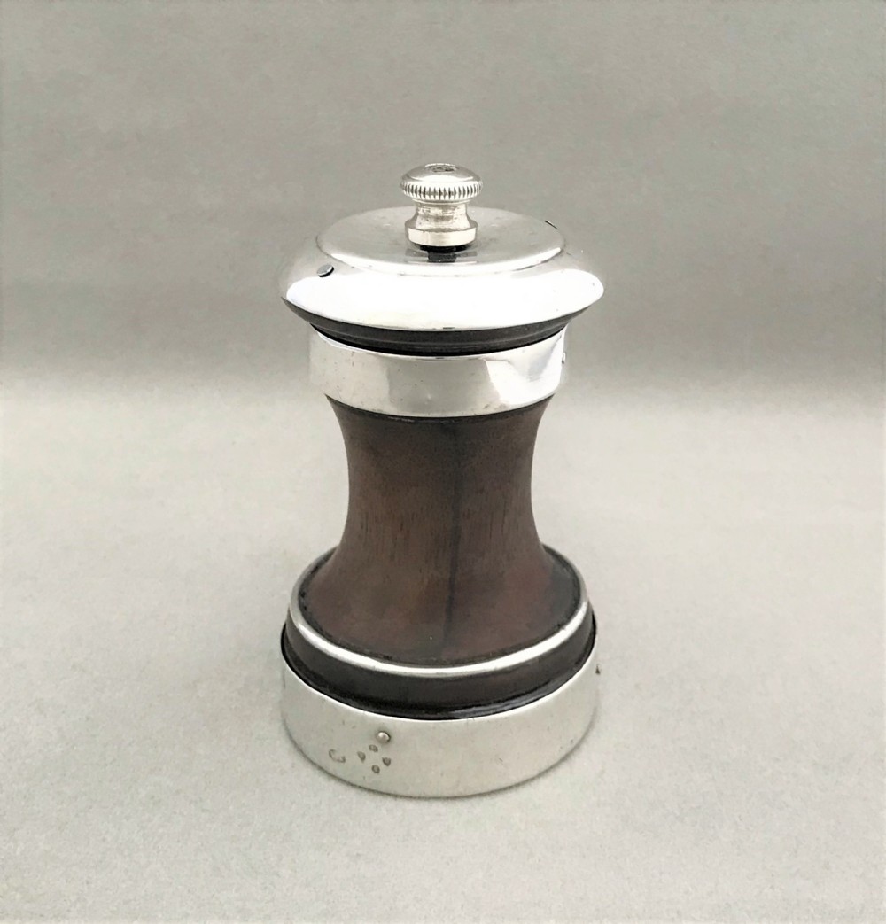 An unusual mid-Victorian silver mounted pepper grinder 