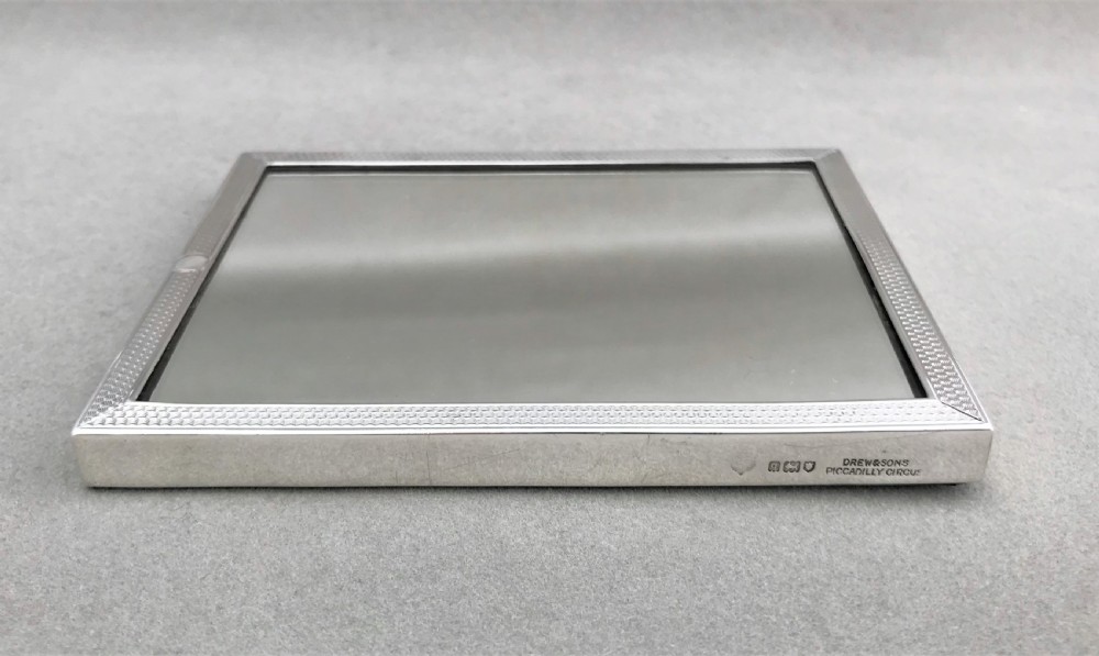 An unusual engine turned silver travelling mirror View V