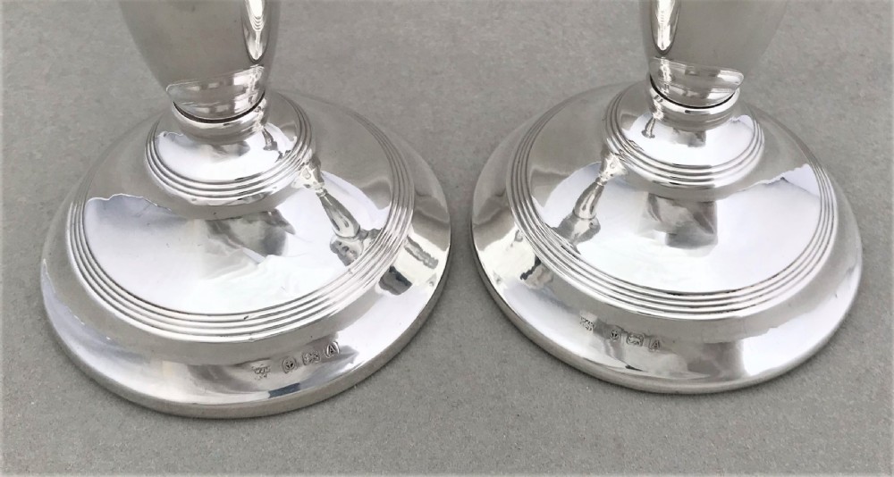 A good pair of dwarf solid silver candlesticks View V