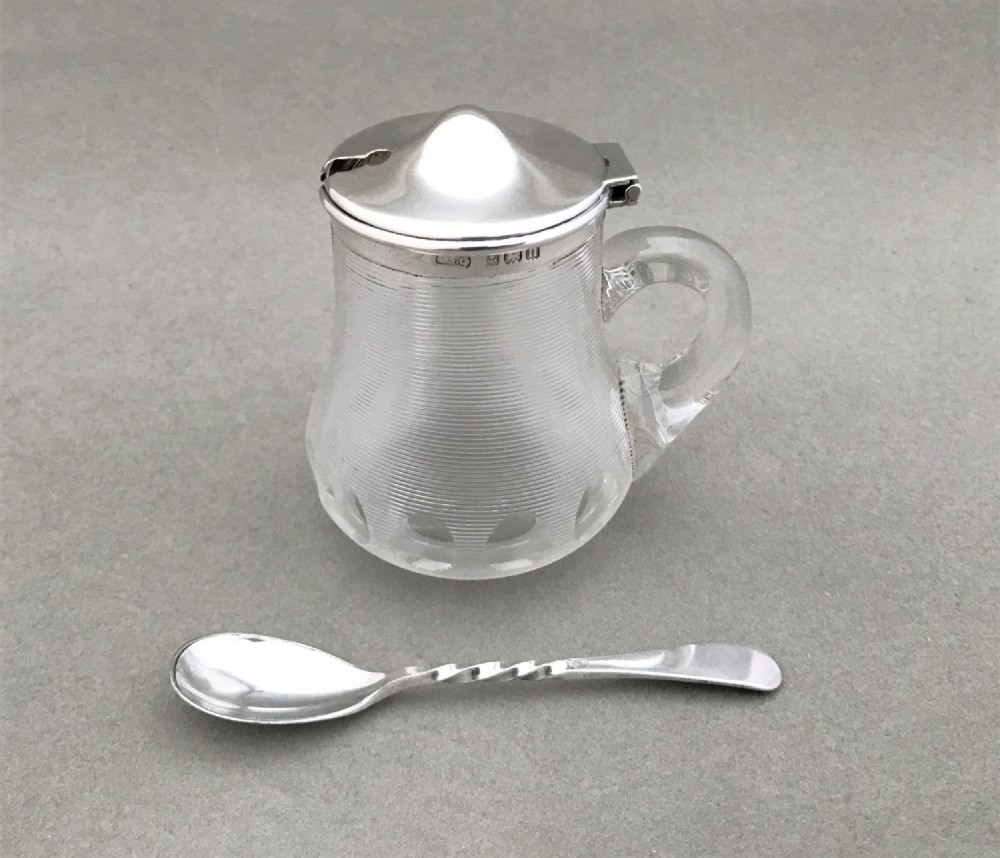 An unusual silver mounted mustard pot & spoon