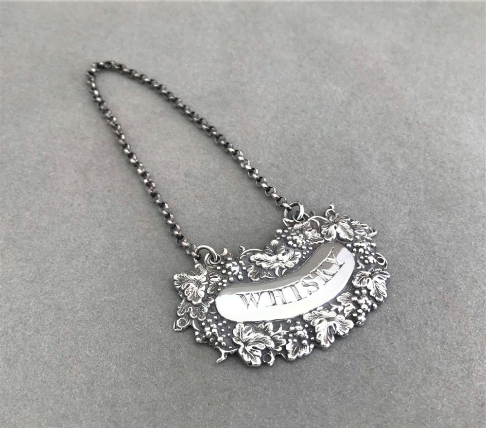 A lovely early Victorian silver Whisky label