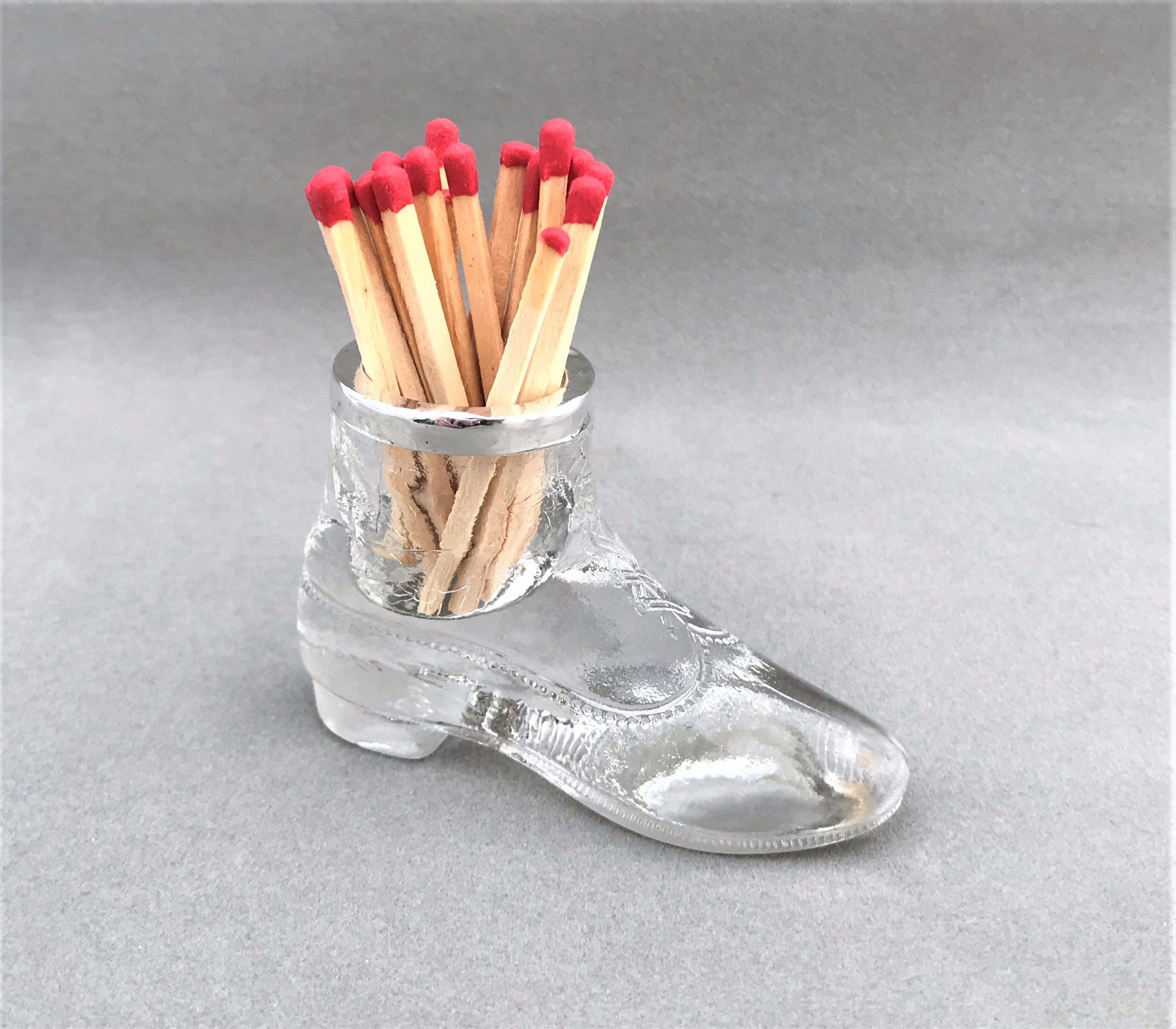 A novelty Edwardian silver mounted 'boot' match striker