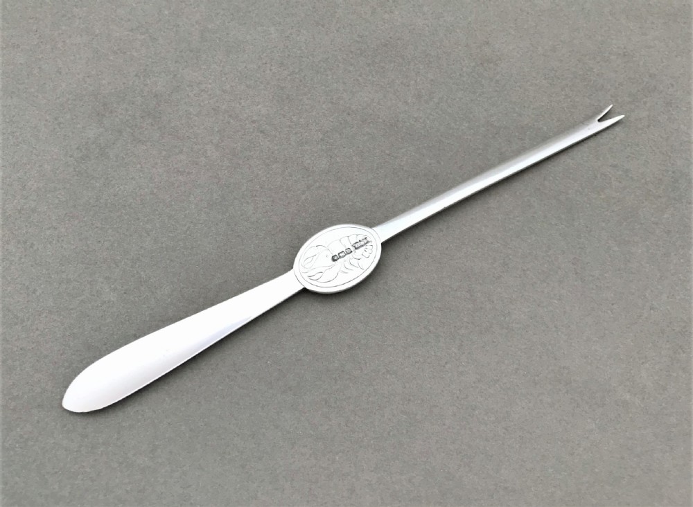 A charming George V silver lobster pick