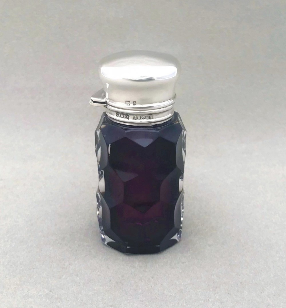 An exquisite Edwardian silver and amethyst glass scent bottle