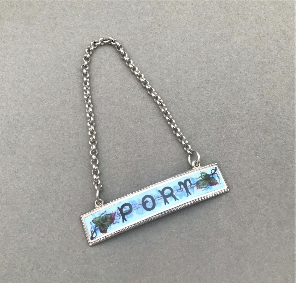 An unmarked silver & enamel Port decanter label