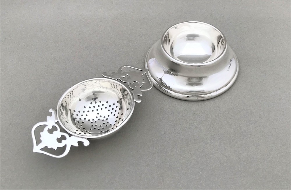 A lovely George VI silver tea strainer & cup View II