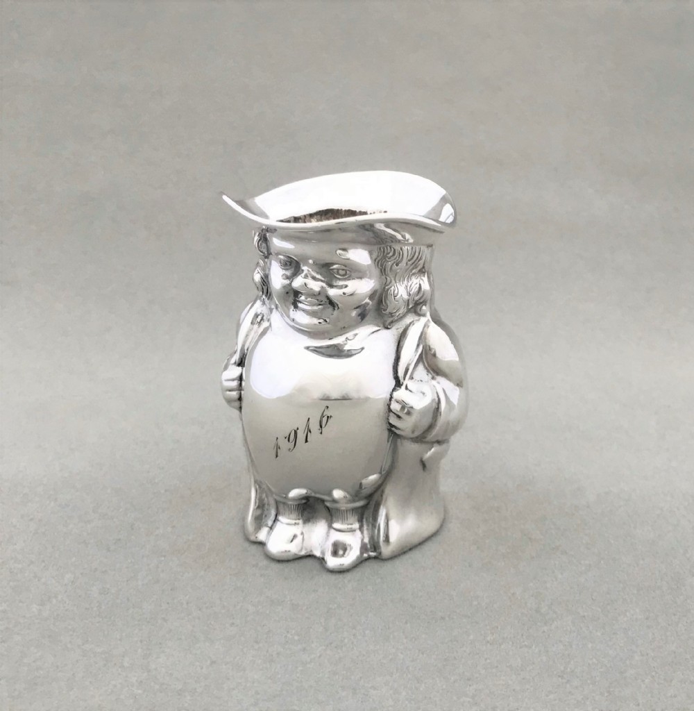 An extremely rare novelty silver Toby cream jug
