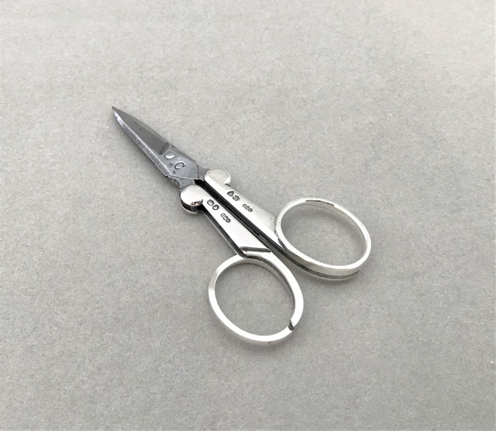A rare pair of Victorian silver folding Campaign scissors