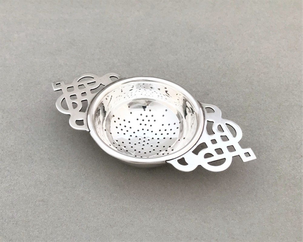 A gorgeous Art Deco silver tea strainer
