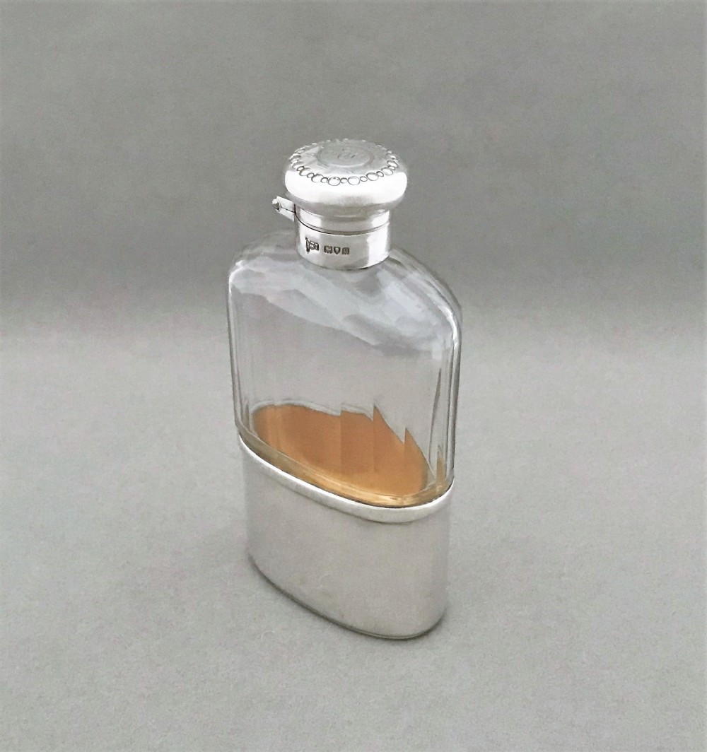 A handsome George V silver & glass hip flask