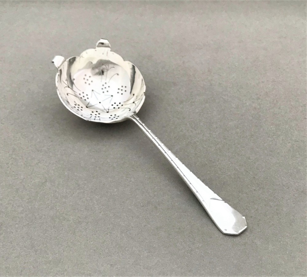 An Art Deco period silver tea strainer View III