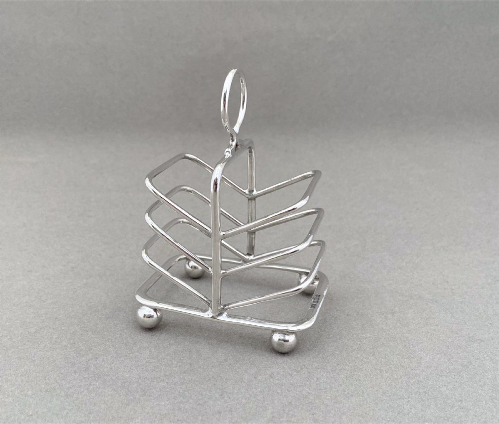 A lovely novelty silver breakfast tray toast rack