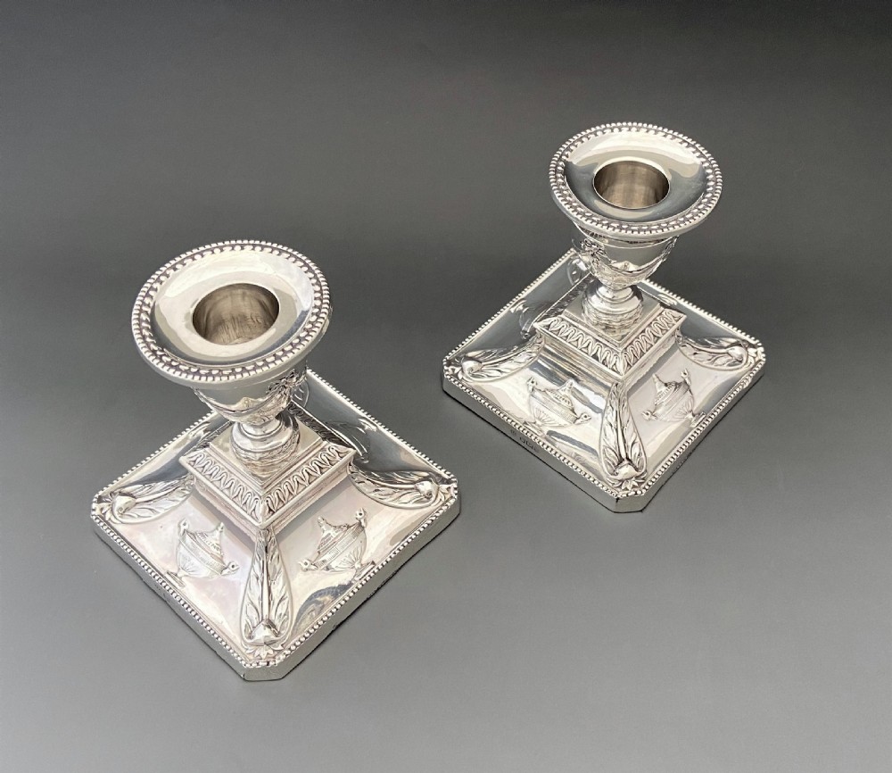 A superb pair of Edwardian silver candlesticks View IX