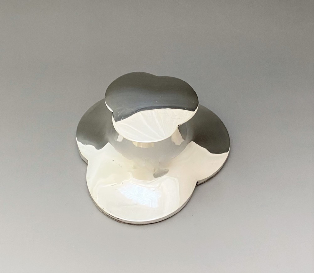 An unusual trefoil silver inkwell