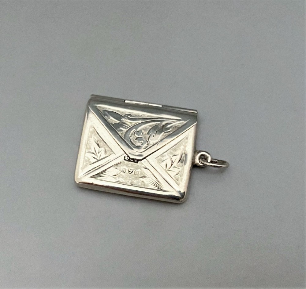 A Chester silver stamp envelope with heart cartouche