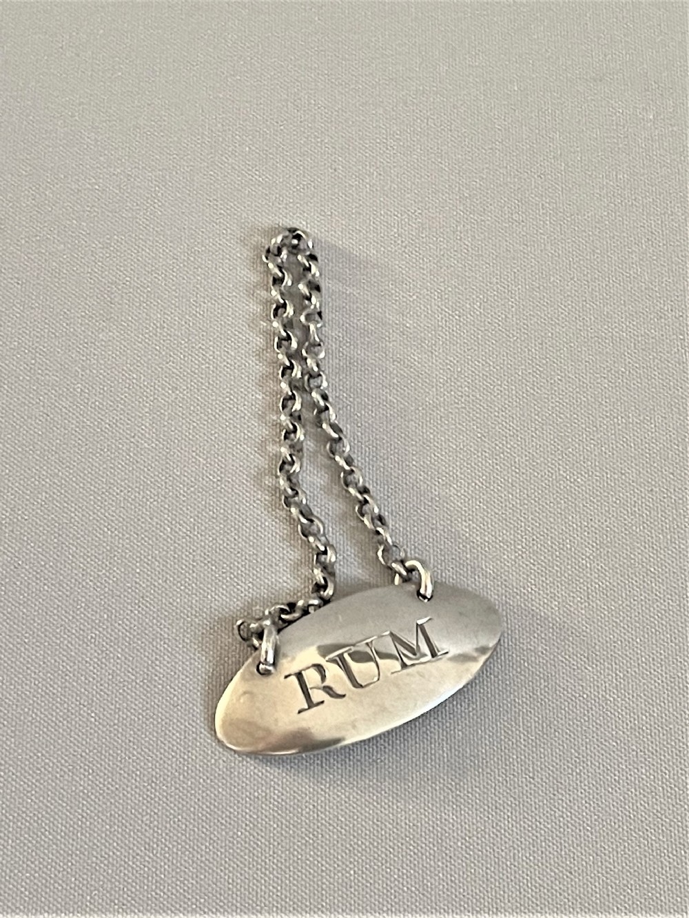 A charming Georgian silver 'Rum' label