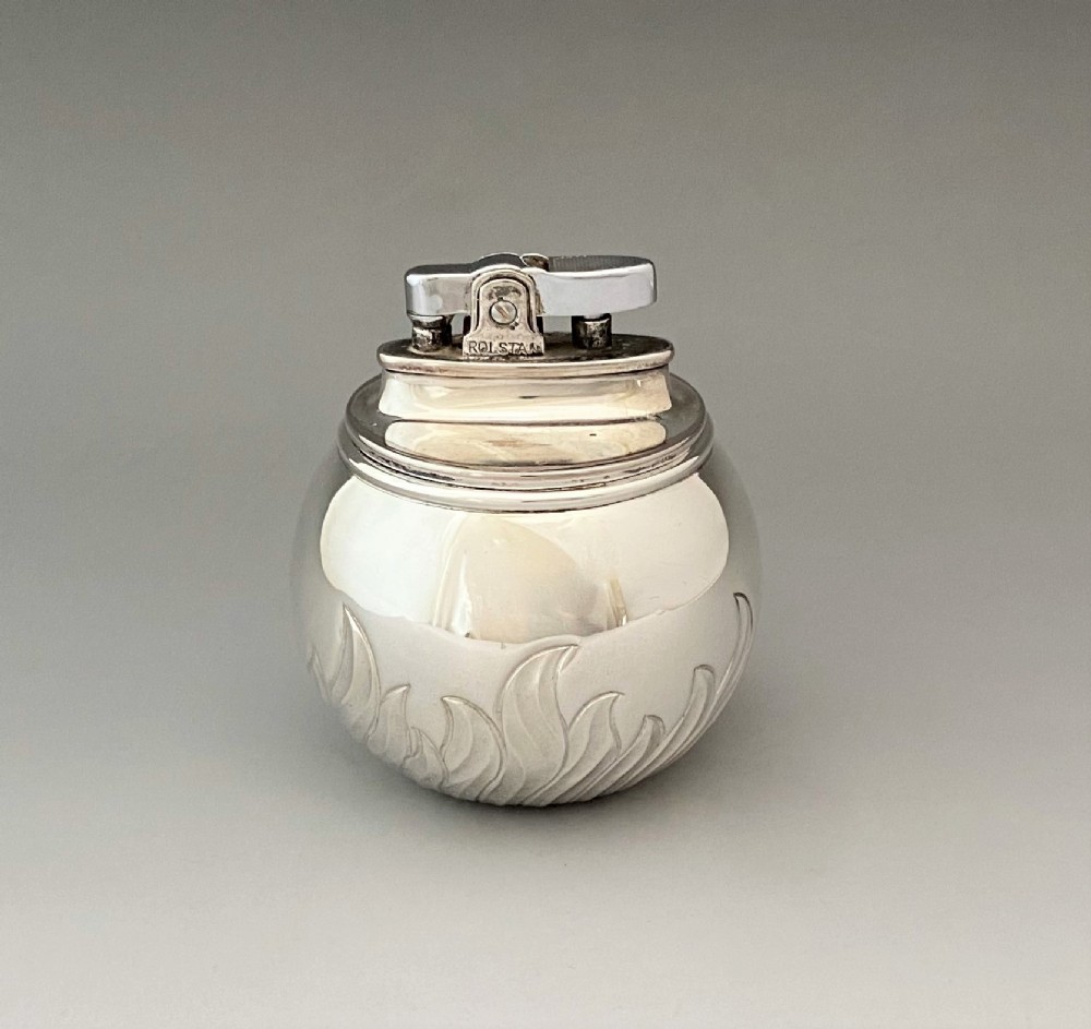 A stylish silver 'witch ball' table lighter by Comyns