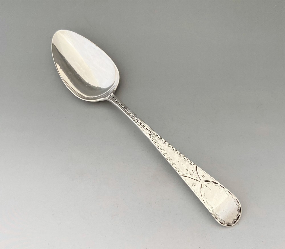 A bright cut Exeter silver table or serving spoon