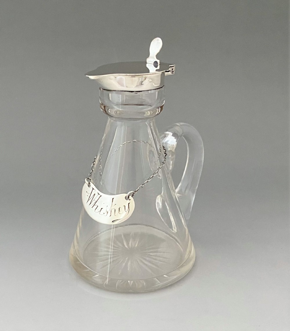 A superb silver mounted Whisky tot and matching silver label