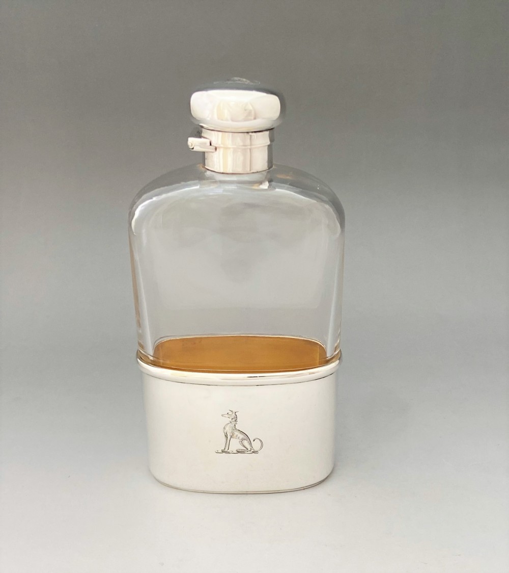 A handsome Edwardian silver mounted hip flask with Greyhound armorial