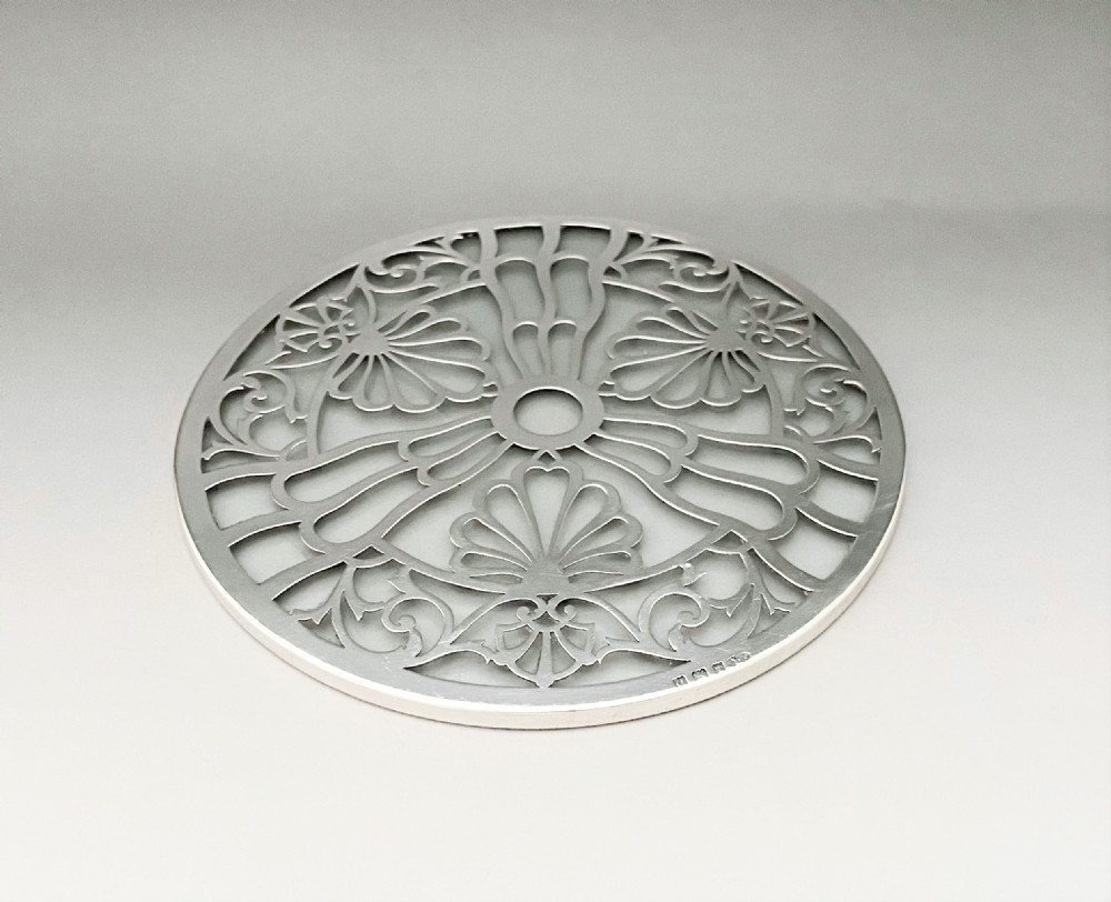 A Gorgeous George V silver teapot stand or coaster