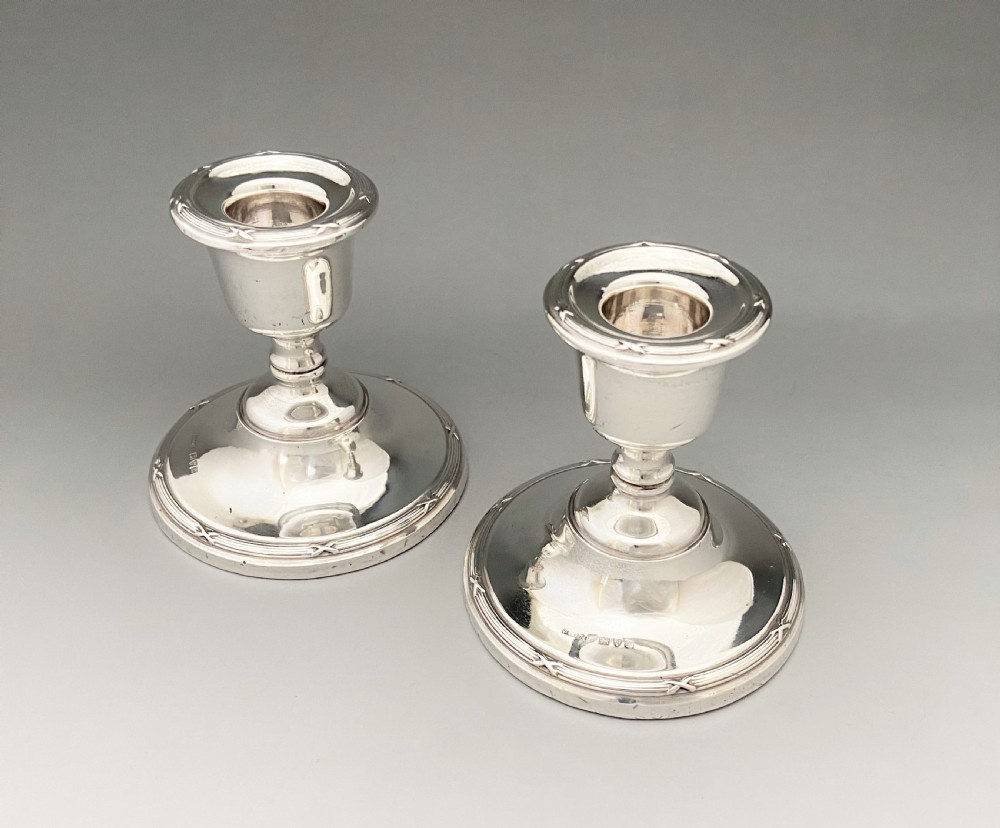 A lovely pair of Chester silver dwarf candlesticks