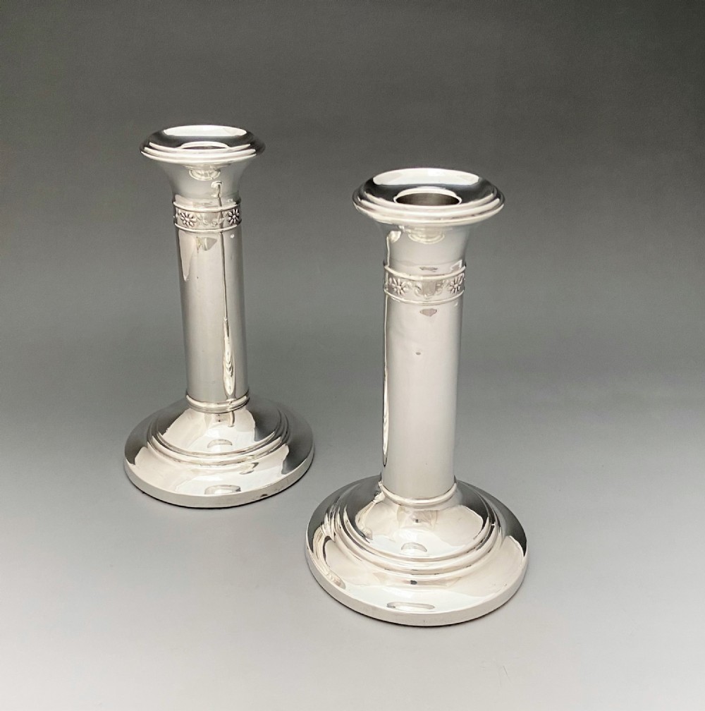 An elegant pair of Edwardian silver candlesticks View III