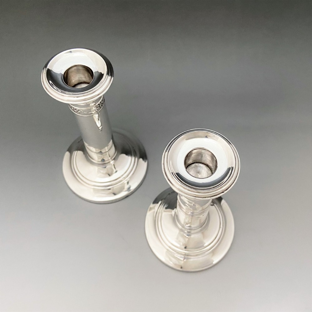 An elegant pair of Edwardian silver candlesticks View IV