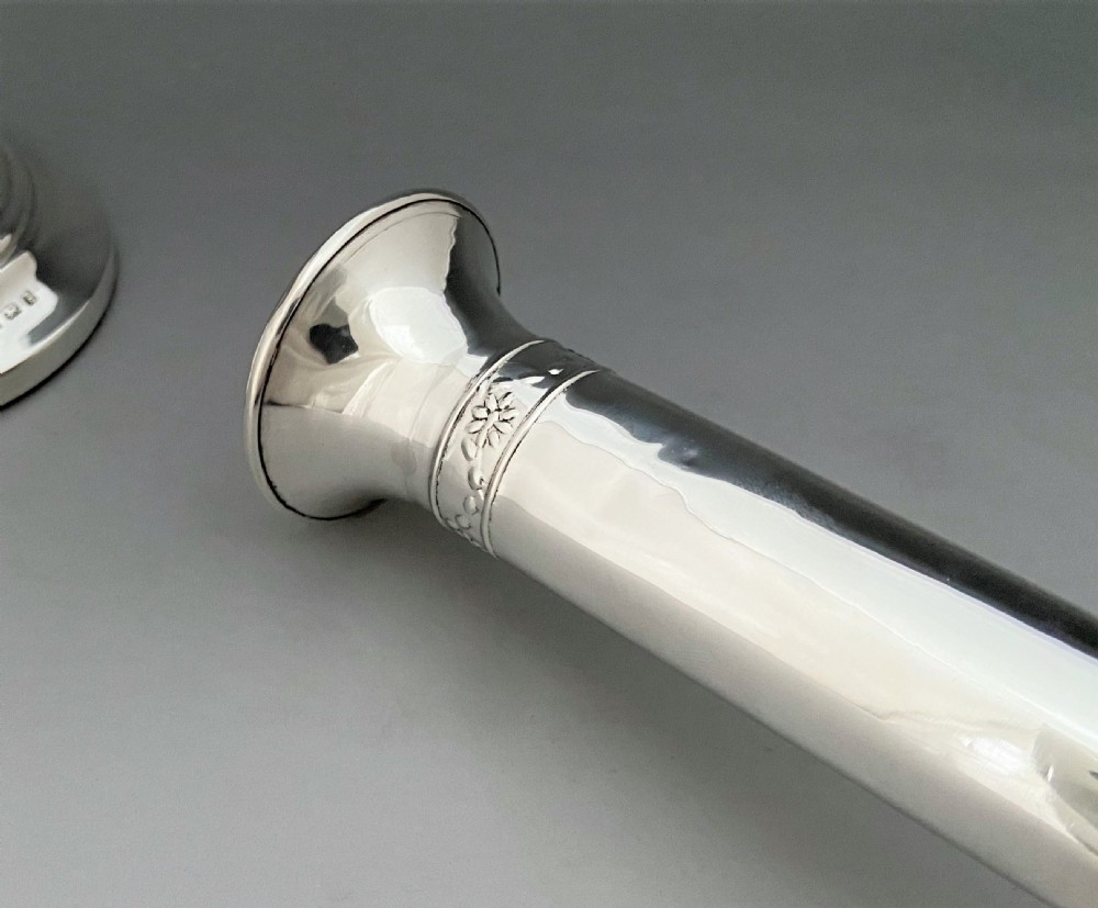 An elegant pair of Edwardian silver candlesticks View VII