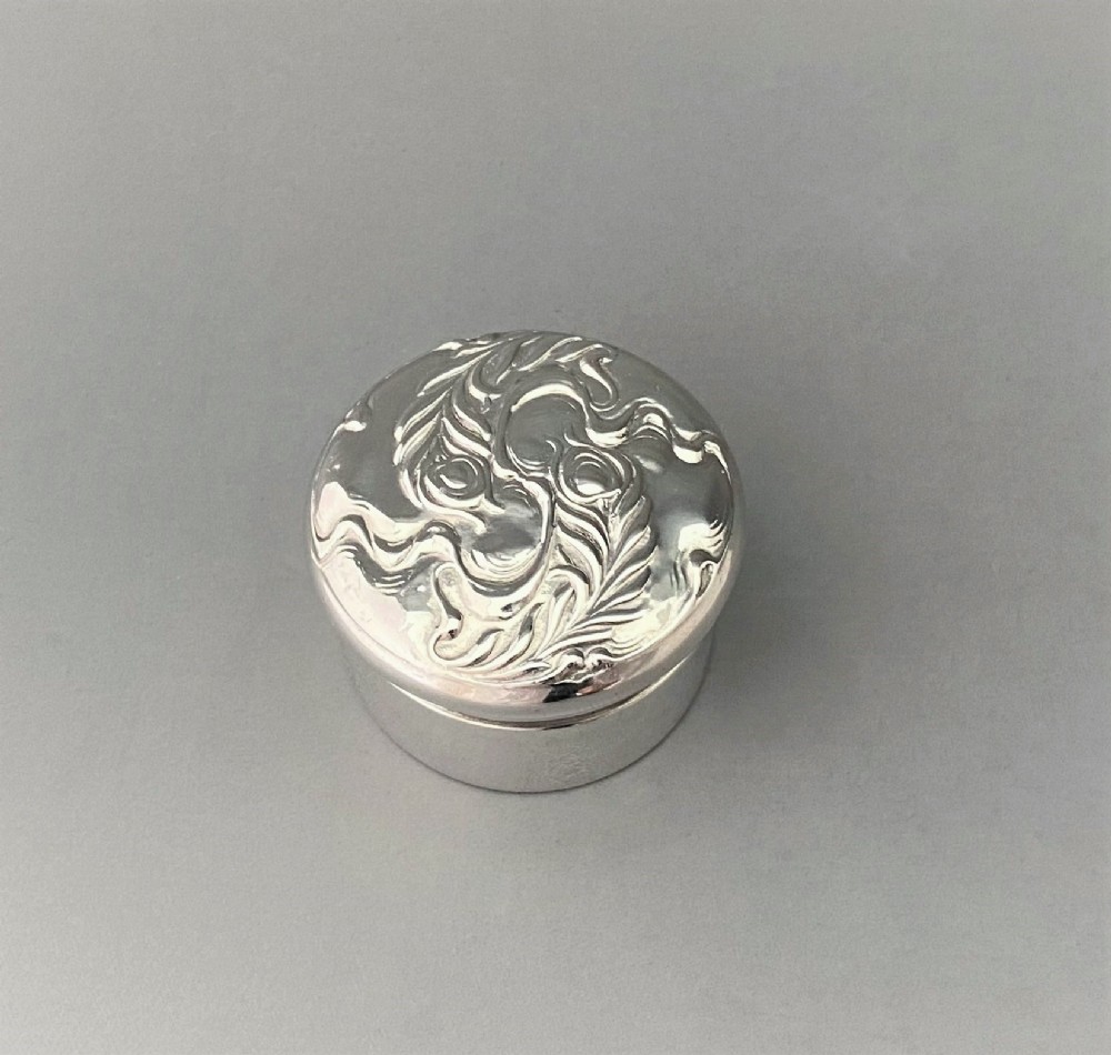 A charming Art Nouveau silver gilt pill box
