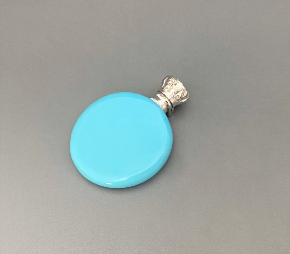 A Victorian silver mounted blue opaline 'penny' scent bottle