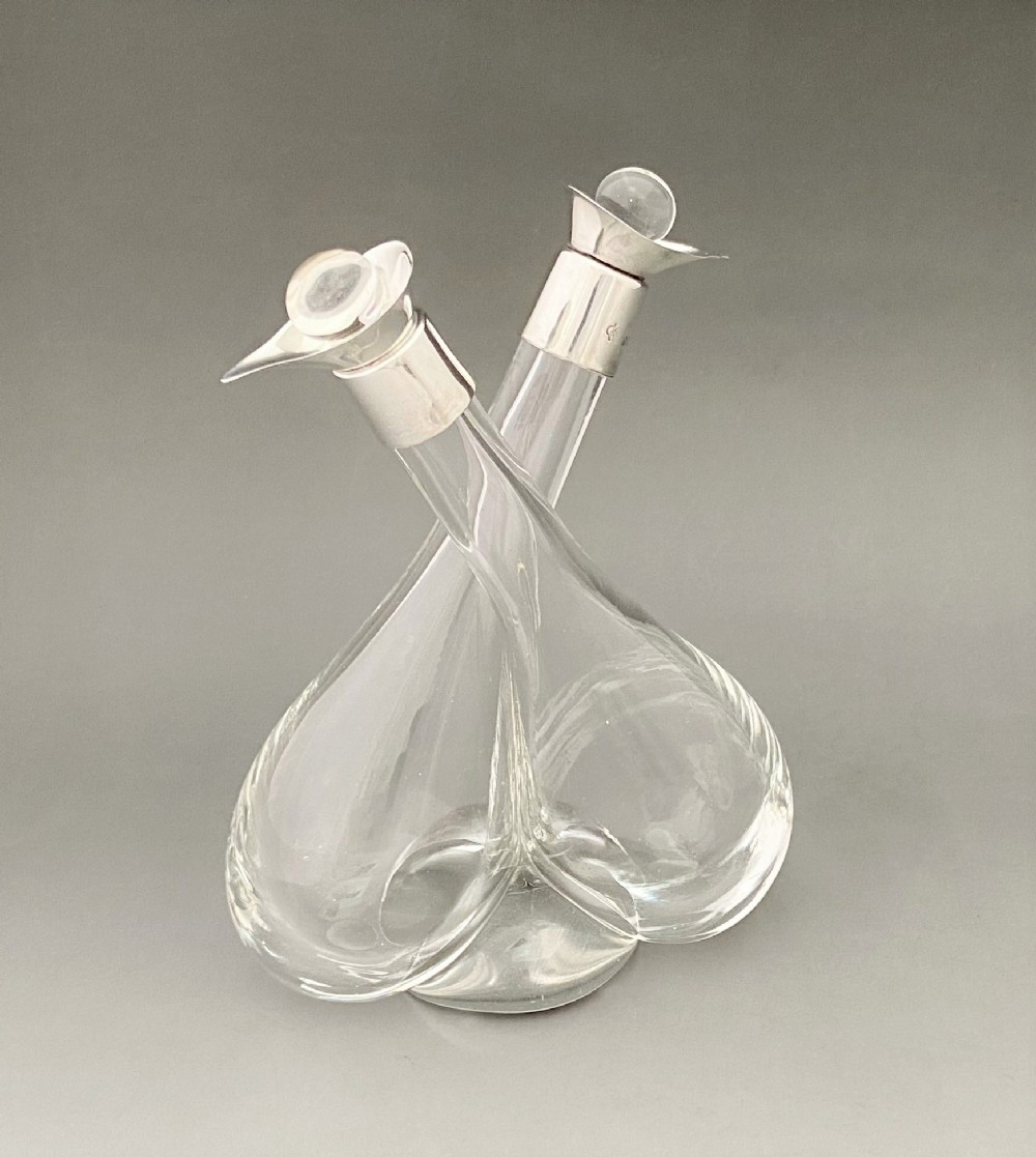 A George V silver mounted oil & vinegar duo