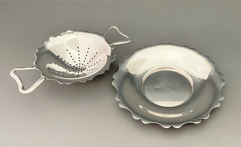 A stylish silver tea strainer & matching drip cup View IV