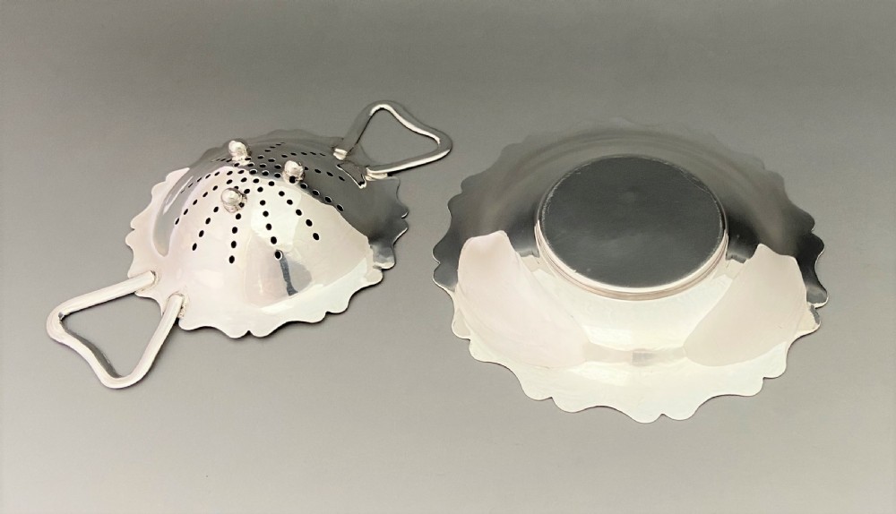 A stylish silver tea strainer & matching drip cup View V