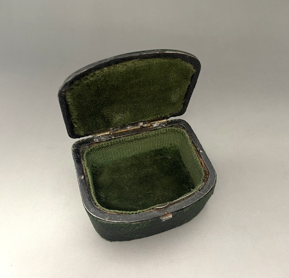 An antique dark green Georgian trinket box featuring a glass lid decorated with white, yellow, and green painted scrollwork motifs. View IV