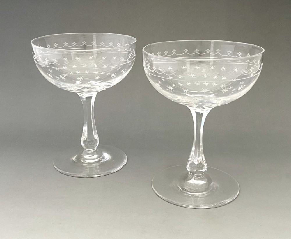 A gorgeous pair of star etched & cut glass champagne glasses