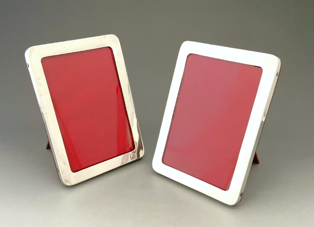 An elegant matching pair of silver photo frames