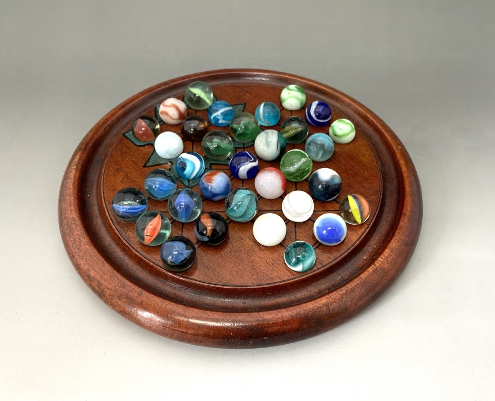 An attractive Victorian Solitaire board & glass marbles