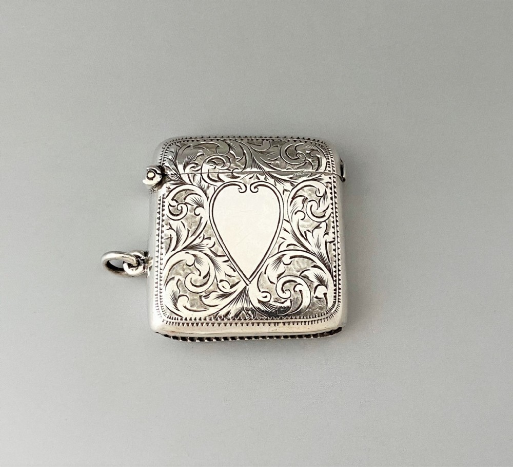 A charming Edwardian silver vesta with heart shaped cartouche