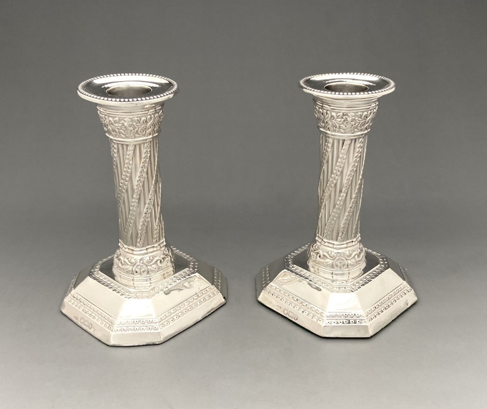 An attractive pair of Victorian silver Corinthian column candlesticks