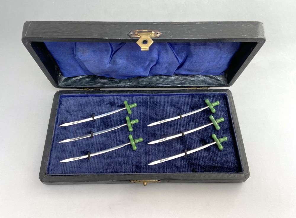 A rare & unusual boxed set of 6 hallmarked silver cocktail sticks
