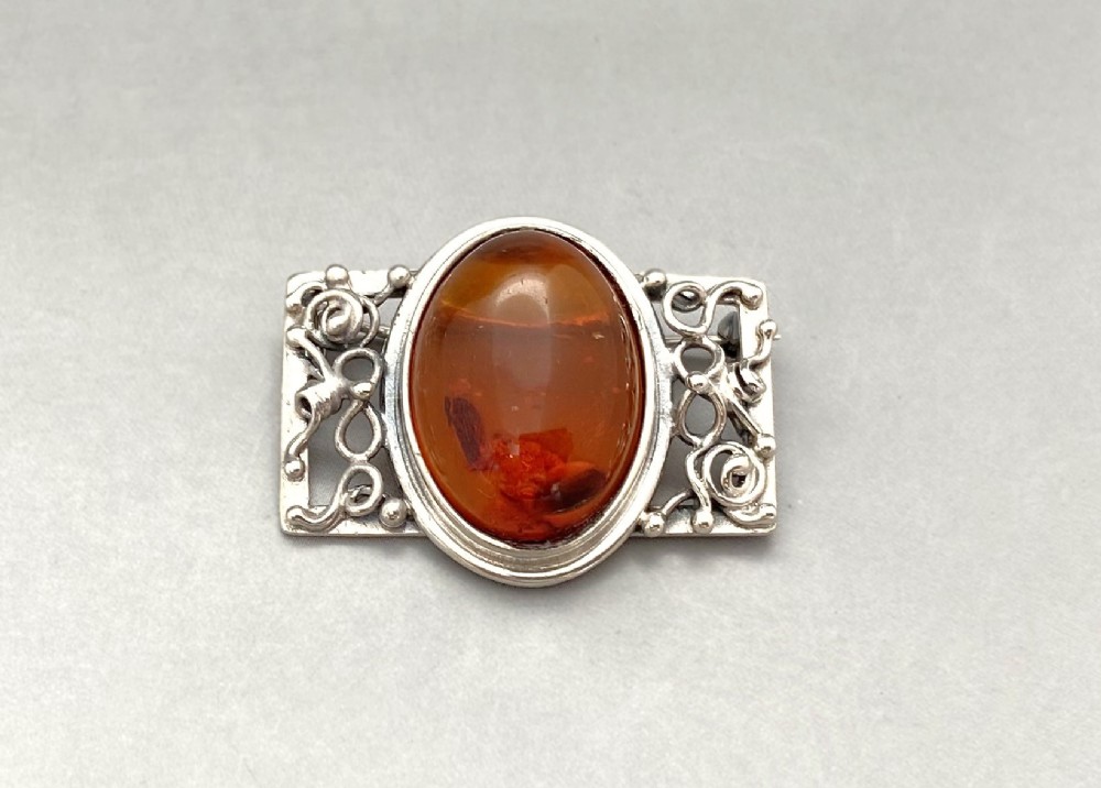 A gorgeous silver & amber brooch