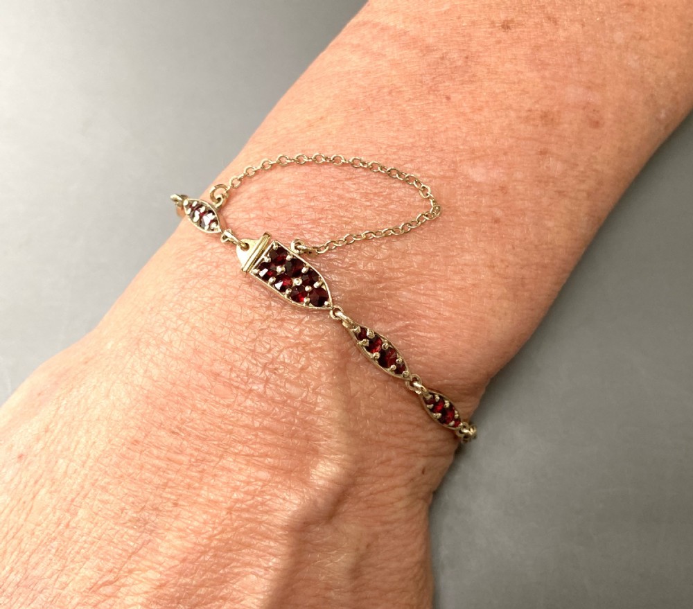 An elegant mid century silver gilt & Garnet bracelet View X