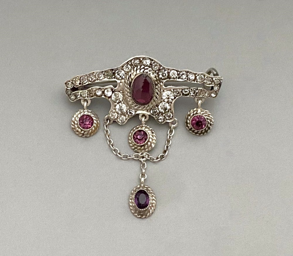 An attractive silver & garnet drop brooch